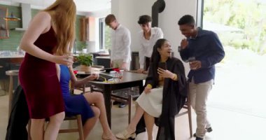 Diplomalı bir kadın masada telefonları kaydırıyor, arkadaşlar içki getiriyor, kadeh kaldırıyor, ortalığı toparlıyor. Kutlama, arkadaşlık, sosyal, modern, neşeli, birliktelik, gündelik