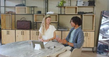 Çeşitli iş arkadaşları ellerinde iPad ve su bardağı tutarak modern çalışma alanında yürüyüp kadeh kaldırıyorlar. Kutlama, takım çalışması, profesyoneller, modern, işbirliği, başarı, canlı