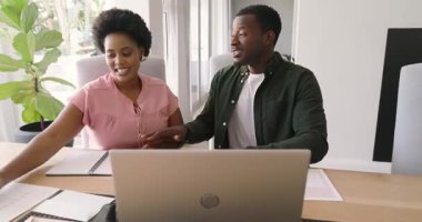 Çeşitli arkadaşlar evde dizüstü bilgisayarla iş birliği yapıyor, proje detaylarını tartışıyorlar. İşbirliği, teknoloji, takım çalışması, ev ofisi, beyin fırtınası, tartışma