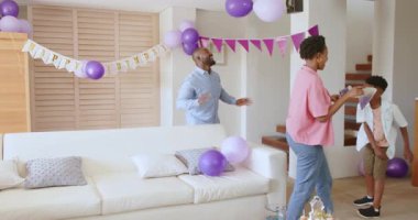 Baba ve oğul evde kutlama için balonlarla oturma odasını dekore ediyorlar. Aile, bağ, parti, dekorasyon, şenlik, birliktelik