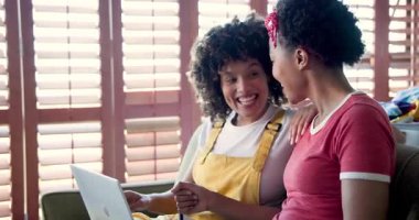 Evde dizüstü bilgisayar ve kredi kartı kullanan gülümseyen kadınlar, online alışverişin tadını çıkarıyorlar. e-ticaret, işlem, dijital, alım, teknoloji, mutluluk