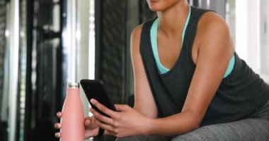 Spor salonunda egzersiz yapan, atletik kolsuz bluz giyen kararlı görünen odaklanmış bir kadın. Spor, spor, egzersiz, eğitim, atlet, motivasyon