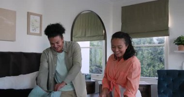 Bebek bezi çantası, bebek için evde bebek kıyafetleri hazırlayan ve akıllı telefondan izleyen bir çift. Aile, hazırlık, annelik, ev, sıcaklık, neşe, bağ