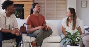 Bir grup arkadaş, rahat oturma odasındaki kanepede sohbet ediyorlar. Arkadaşlık, birliktelik, sosyalleşme, çeşitlilik, rahatlık, toplanma.