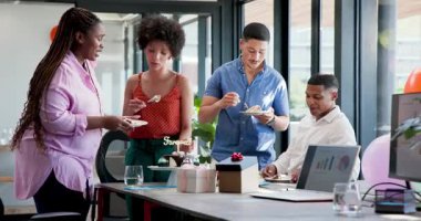 Çeşitli iş arkadaşları modern ofiste ekip üyelerini tebrik ediyor, pasta ve iyiliklerle kutluyorlar. Kutlama, takım çalışması, şirket, ofis, toplama, kültür, başarı