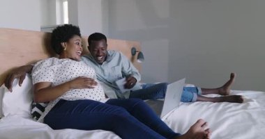 Video sohbeti, yatakta bekleyen farklı çiftler, evde ultrason görüntülerine sevinçle bakıyorlar. hamilelik, annelik, aile, bağlanma, beklenti, samimiyet