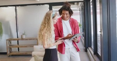 Çeşitli iş arkadaşları ofiste sandalyeyi tablet ve akıllı telefonla itip kutluyorlar. Kutlama, takım çalışması, işbirliği, modern, teknoloji, şirket, pozitiflik