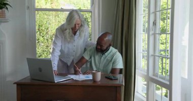 Üst düzey çift ev bilgisayarlarıyla dosya incelemesini tamamlıyor, kağıtları yırtıyorlar, sarılıyorlar, gülüyorlar. İşbirliği, başarı, kutlama, bağlantı, profesyonellik, sıcaklık, neşe