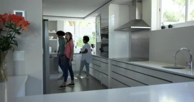 Beyaz mutfakta pano rehberi olan Afro-Amerikan bir ajan, indirimi kutluyor. Gayrimenkul, ev turu, modern mutfak, emlak denetimi, müşteri danışmanlığı, iç tasarım, yaşam tarzı