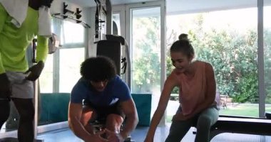 Genç çift spor salonunda antrenörleriyle esneme hareketleri yapıyor, esnekliğe odaklanıyor. Fitness, egzersiz, egzersiz, eğitmen, eğitim, aktif