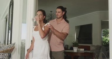 Verandada şarap kadehi tutan çift, nişan yüzüğü kutusuyla içeri giren adam, evlenme teklif ediyor ve sarılıyor. Romantizm, kutlama, sevgi, yakınlık, zarafet, açık hava, neşe