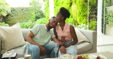 Genç çift açık verandada sodalı su ve sohbetin tadını çıkarıyor. içecek, rahatlama, açık hava, beraberlik, ferahlık, keyif