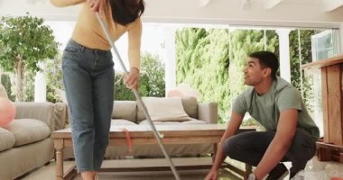 Genç çift oturma odasında birlikte parti dekorasyonlarını temizliyor. Temizlik, takım çalışması, ev, derleme, kutlama, işbirliği