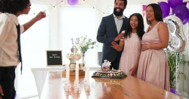 Çeşitli aileler geleneksel törenleri kutluyor, evde mumları kucaklıyor ve yakıyor. Bar mitzvah, bat mitzvah, Aile, ebeveynlik, gelenek ve kutlama konsepti.