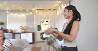 Doğum günü pastasında mum üfleyerek doğum günü partisi veren bir grup mutlu, çok ırklı ve beyaz bayan arkadaş. Kutlama, doğum günü, parti, yaz ve arkadaşlık kavramı.