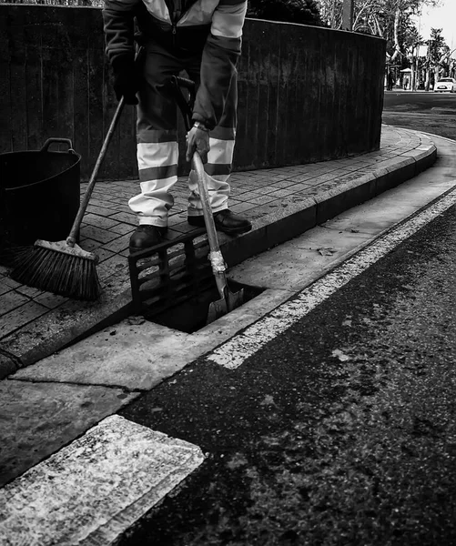 Man cleaning streets, sweeper job, occupation