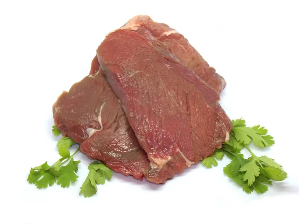 パセリの白い背景の上に新鮮な生の牛肉ステーキ — ストック写真