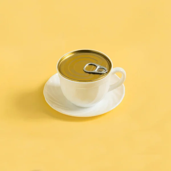 Cup of coffee like tincan on yellow background. Minimal style. Creative idea, imagination and fantasy. Original food concept: food and storage