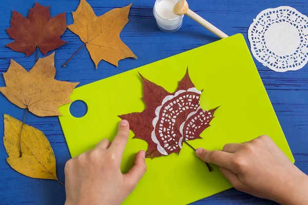 Hand-painted on dry autumn leaves by dint of paper lace napkin. Children\'s art project. DIY concept. Step by step photo instructions. Step 3. Dry drawing