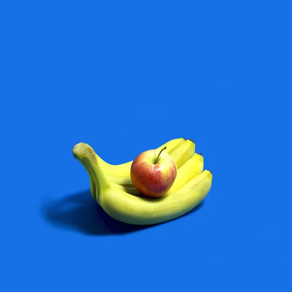 Apple lies on bananas like on open palm of hand. Take fruit. Creative idea, imagination and fantasy. Minimalism. Fashionable bright colors. Original food concept