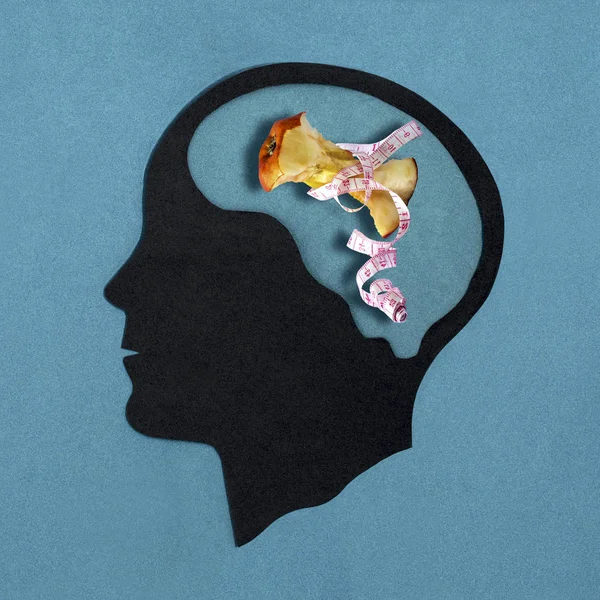 Stylized head silhouette. Brain with apple stub in measuring tape. Pathological food restriction. Anorexia nervosa. Concept of mental health and disease — Stock Image Stylized Head Silhouette Brain Apple Stub Measuring Tape Pathological Food Stock Image