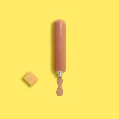 Sausage as a tube of paint. Constructed, artificial objects that mimic natural forms. Minimal style. Creative idea, imagination and fantasy. Original pop art concept clipart