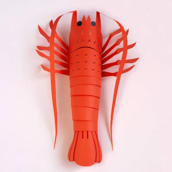 Paper lobster on peach color background