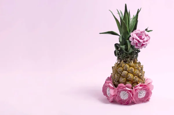 Pineapple decorated with paper flowers