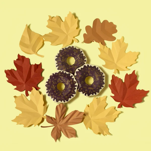 Paper donuts in wreath of paper autumn leaves