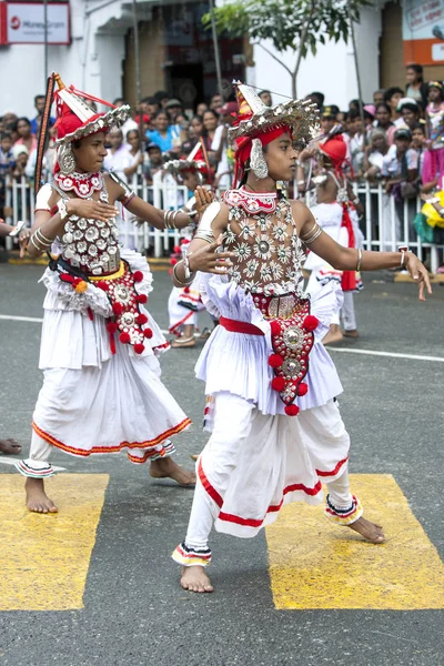 Up Country Dancers perform on the streets of Kandy in Sri Lanka during the Day Perahera. This parade takes place on the final day of the Esala Perahera which is held to honour the sacred tooth relic of Buddha.