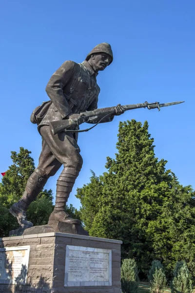 A statue depicting a World War One Turkish soldier holding his rifle with the inscription Canakkale Turkusu on the Gallipoli Peninsula in Turkey.