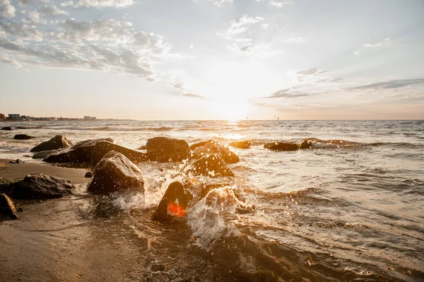 Морський пейзаж багато каменів на пляжі під час заходу сонця — стокове фото
