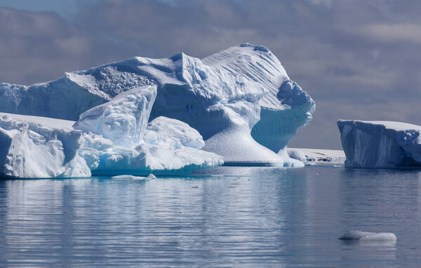 Travel along Antarctica on the scientific vessel. Studying of ices, sea inhabitants and global warming. Icebergs of various forms and colours.