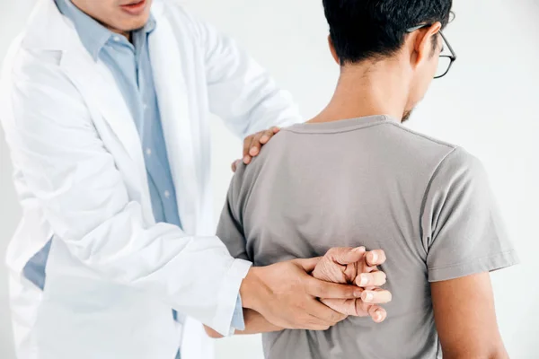 Physiotherapist doing healing treatment on man's back.Back pain