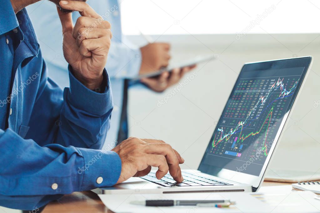 Businessman analyzing stock market report and financial dashboar