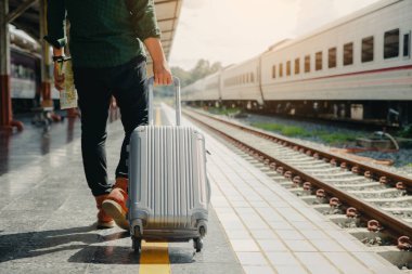 Genç turist drag bagaj yürüyüş. diğer el m tutarak