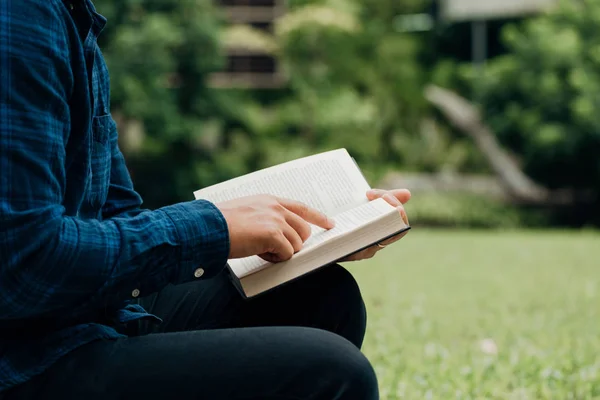 Christians and Bible study concept.Young Man sitting reading the