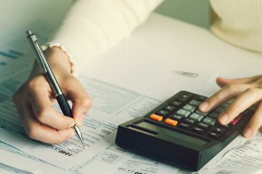 ABD vergi formunu dolduran kadınlar. Vergi formları iş gelirleri ofisi elle doldurma kavramı. Evden çalışma.