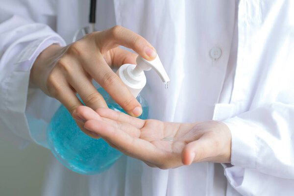 Closeup of doctor hand pressing the hand sanitizer gel and protect from coronavirus, antibacterial