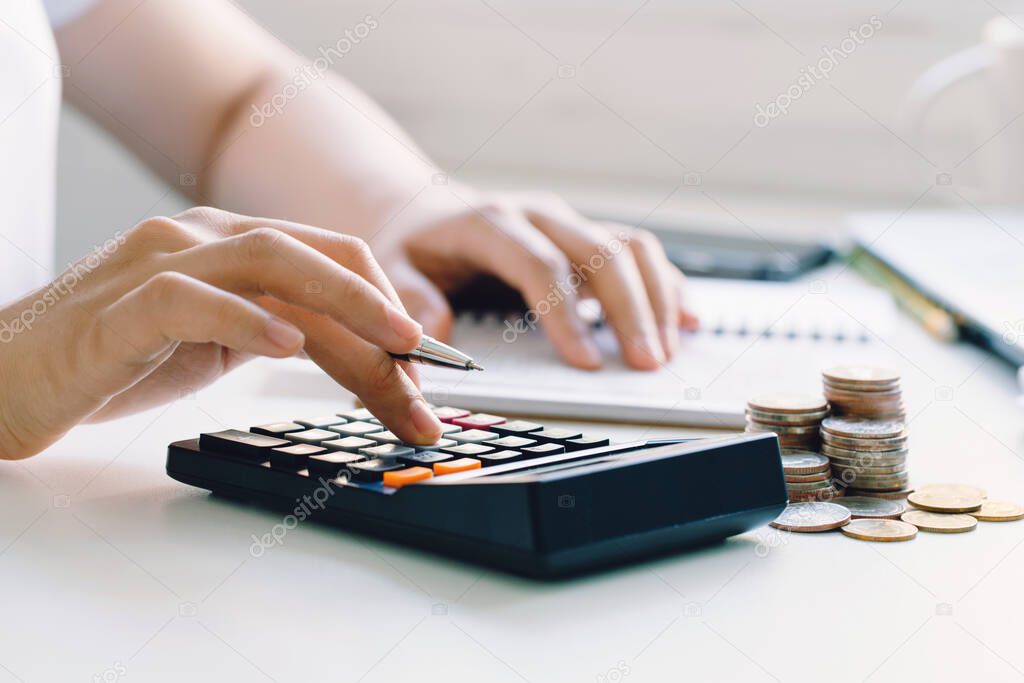 Young woman calculating monthly home expenses, taxes, bank account balance and credit card bills payment.income tax for pay taxes 