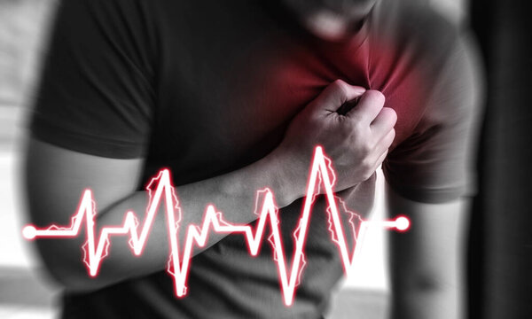 Heart attack.Man clutching his chest from acute pain.having heart attack or painful cramps, pressing on chest 