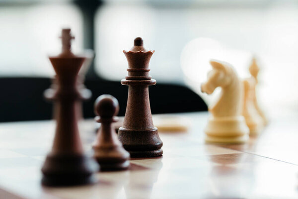 wood chess pieces on board game., strategy and competition in business concept.