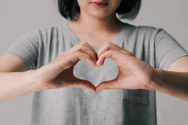 Woman making hands in heart shape, donation, happy charity volunteer, world heart day concept