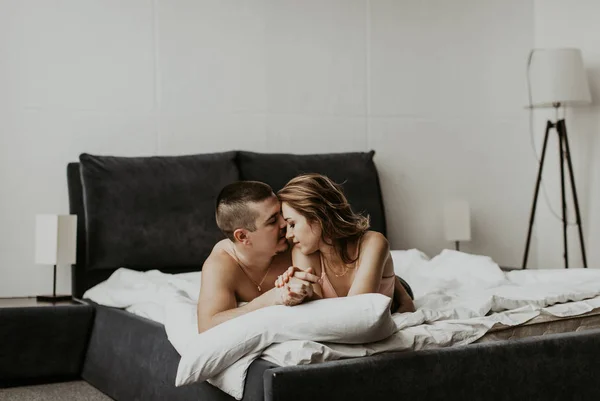 beautiful couple kissing in bed