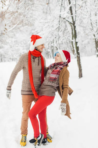 couple in love lie in the snow, laugh and enjoy