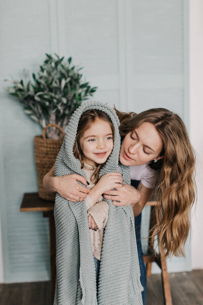 молодая мать обнимает свою дочь
