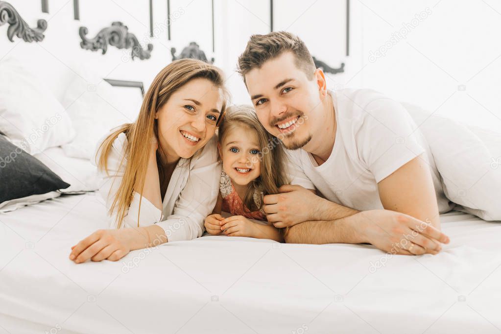  happy family plays and enjoys in bed      