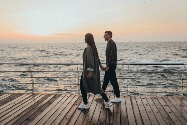 Beautiful loving couple walking at sunset