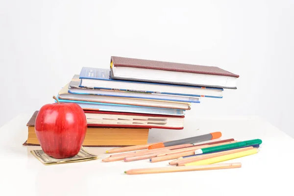 colorful Books and ripe Apple in the us with School supplies lyi
