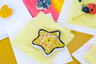 Çocuk bir kil figürü gıyabında boyuyor